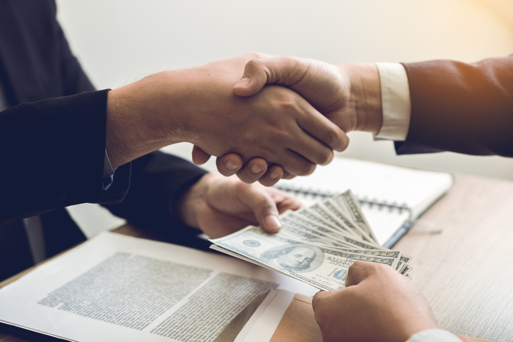 Business Partners Shaking Hands and Paying Money